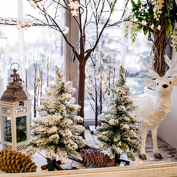 Christmas scene with burning candle and christmas decorations on winter windowsill