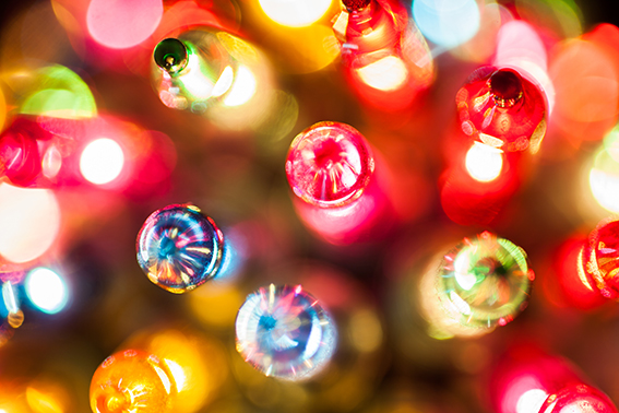 Christmas tree lights bulbs closeup on bokeh colorful