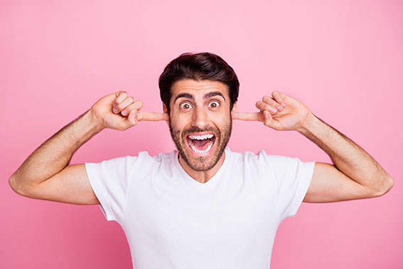 Close up photo of funny funky middle eastern man close cover ear index, finger dont want listen about wonderful sales discounts wear white outfit clothes isolated over pink color background