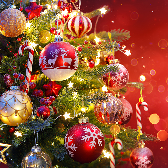 Christmas Tree With Ornament And Bokeh Lights In Red Background