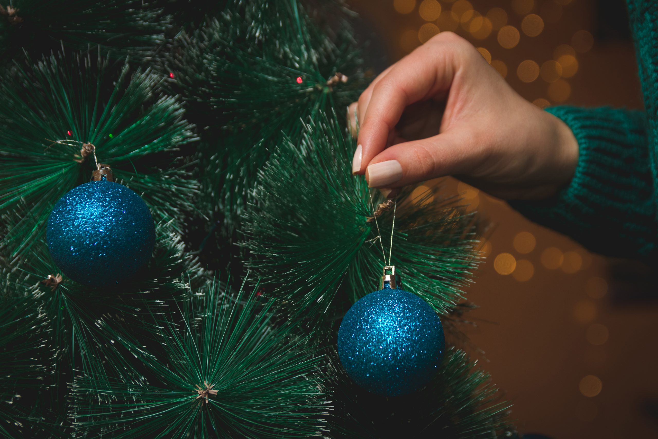 Girl decorates a Christmas tree