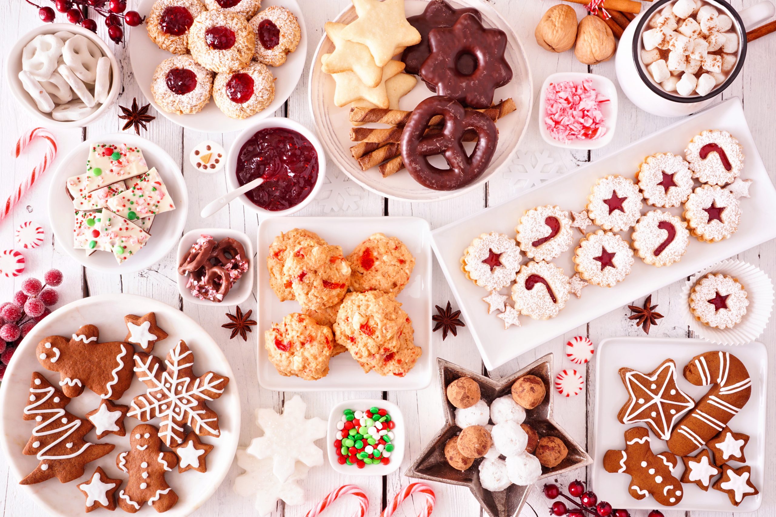 Christmas sweets and cookies. Top view table scene over a white wood background. Holiday baking concept.