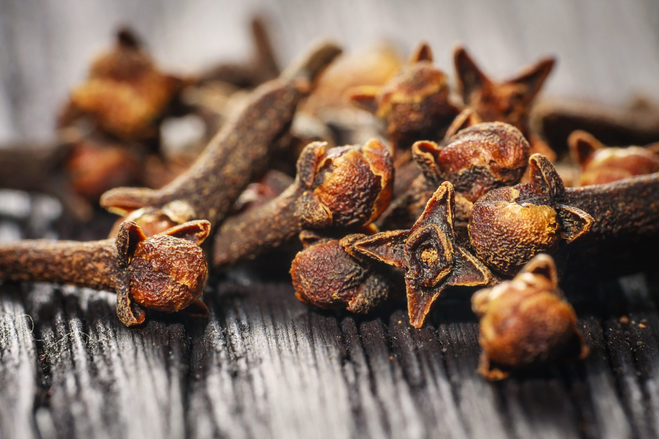 pile cloves on wood background